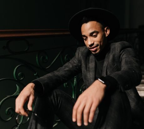 refined-young-male-model-posing-steps-indoor-photo-pensive-well-dressed-black-guy-looking-down_197531-22069